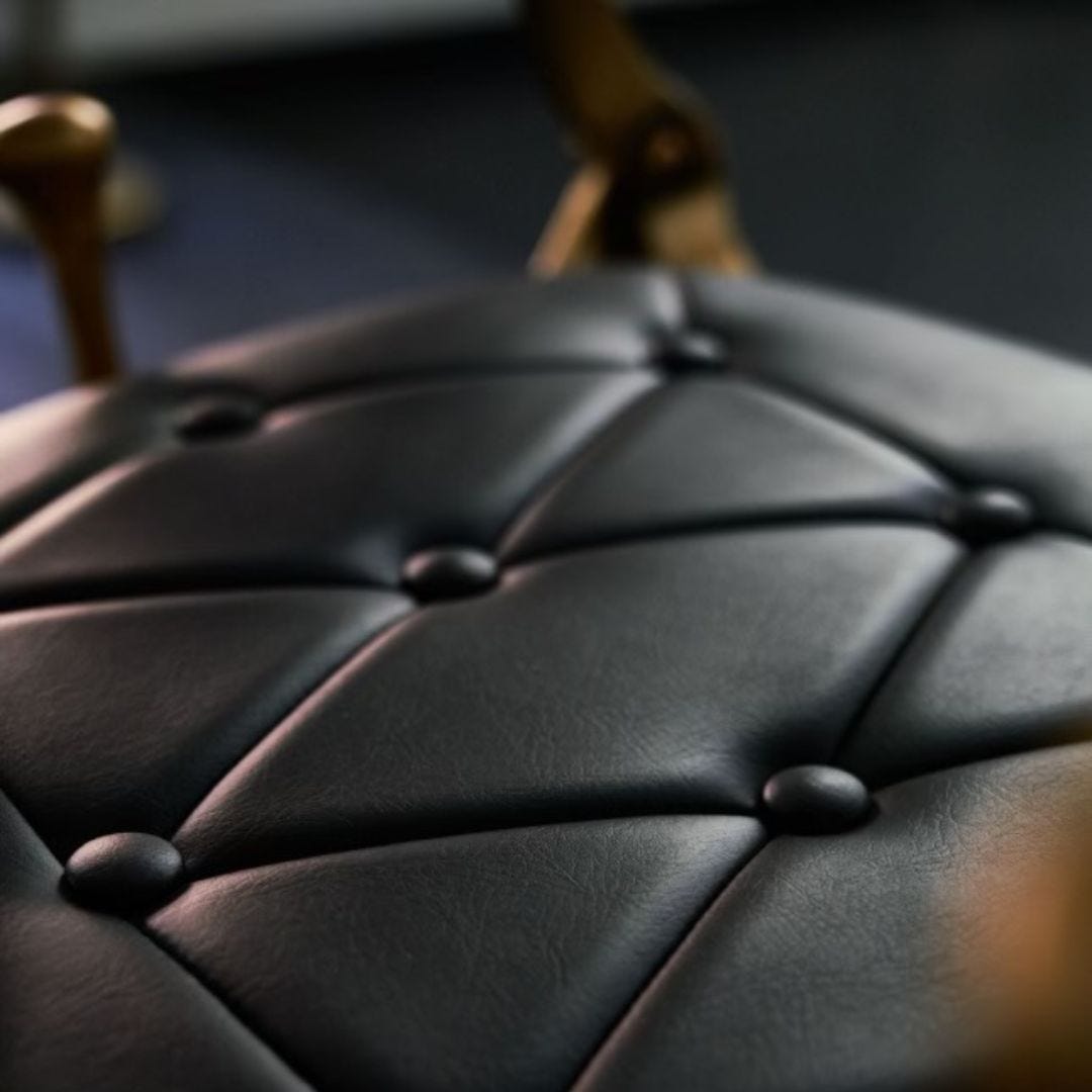 close-up view of commercial-grade vinyl upholstery on barber chair seat