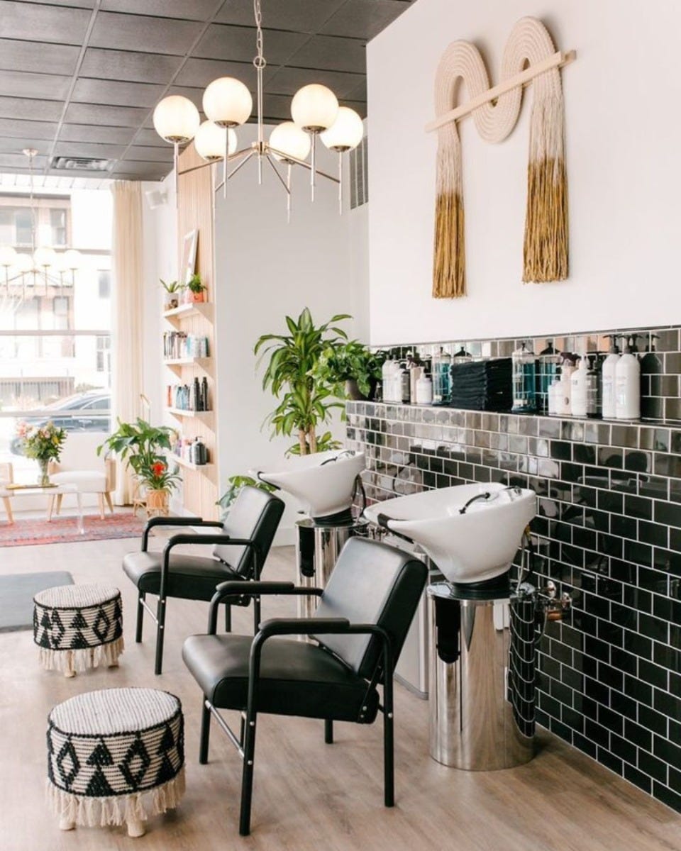 two shampoo sink and chair sidewash stations in a chic salon