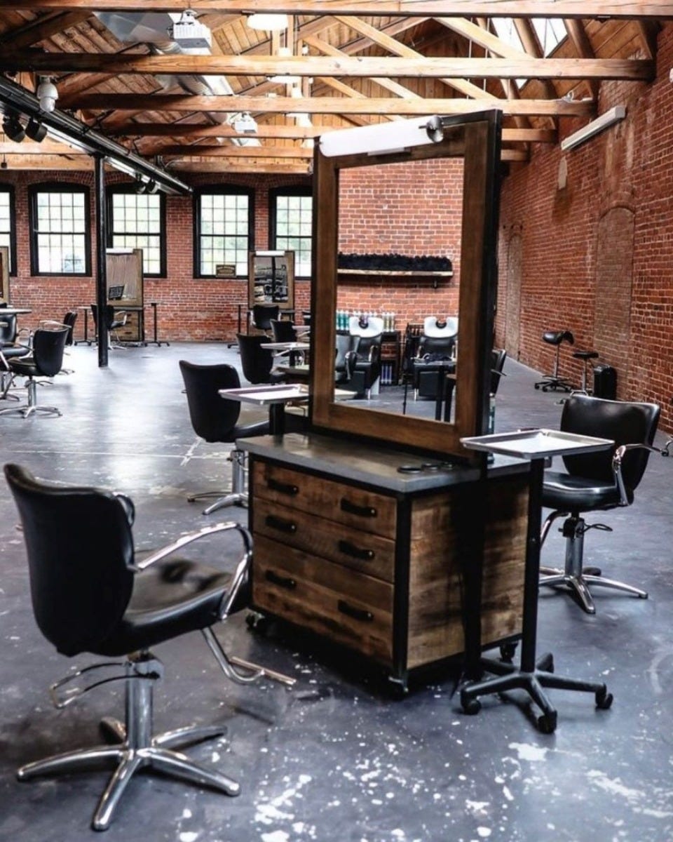 double-sided salon stations made from eco-friendly materials in an open-concept loft-style hair salon