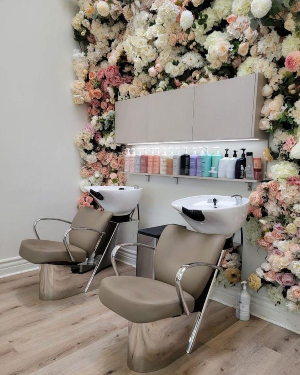 shampoo sidewash stations with a floral wall and retail products