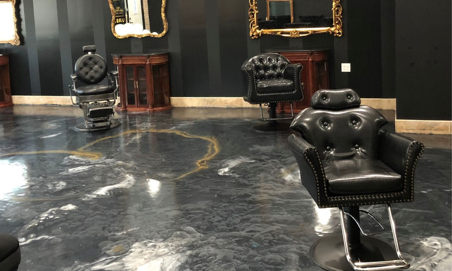 three different all-purpose reclining salon chairs in a high-end barbershop setting
