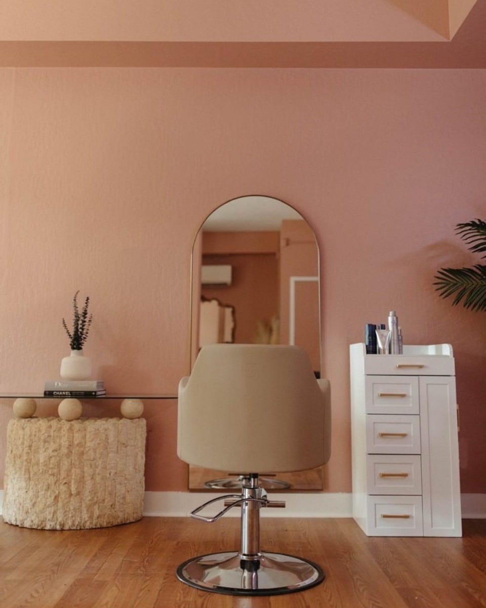 modular styling station including cabinet, tabletop and arched mirror in luxurious chic hair salon