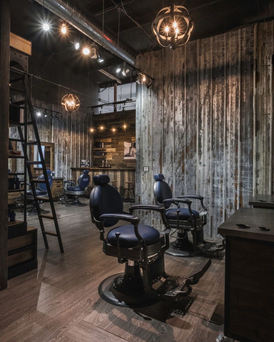 four barber chairs in an open concept barber shop with proper spacing between them