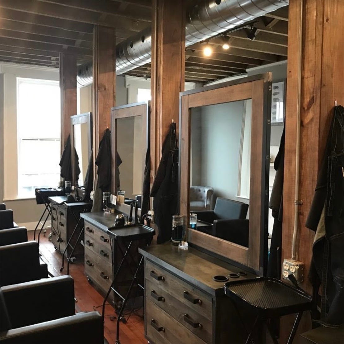 barber stations with essential tools and accessories including capes, styling tools and cutting tools